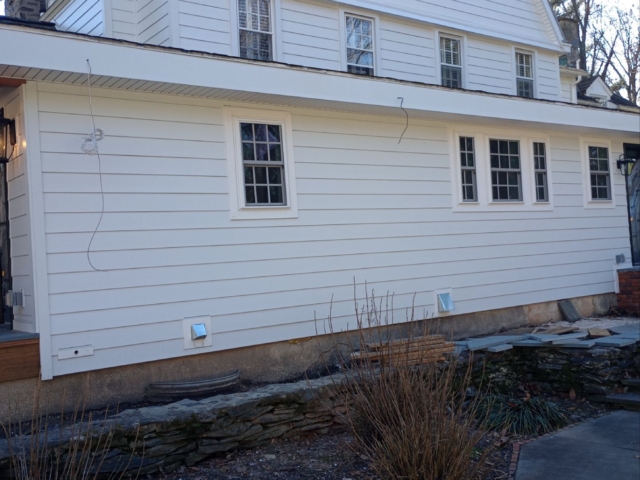 James Hardie siding on a Gladwyne PA home with clean trim, arched window detail and lower maintenance exterior