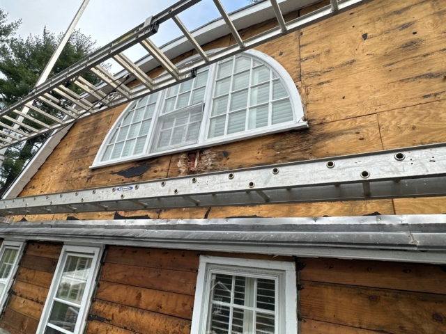 Gladwyne PA home with old siding removed around arched window before exterior renovation