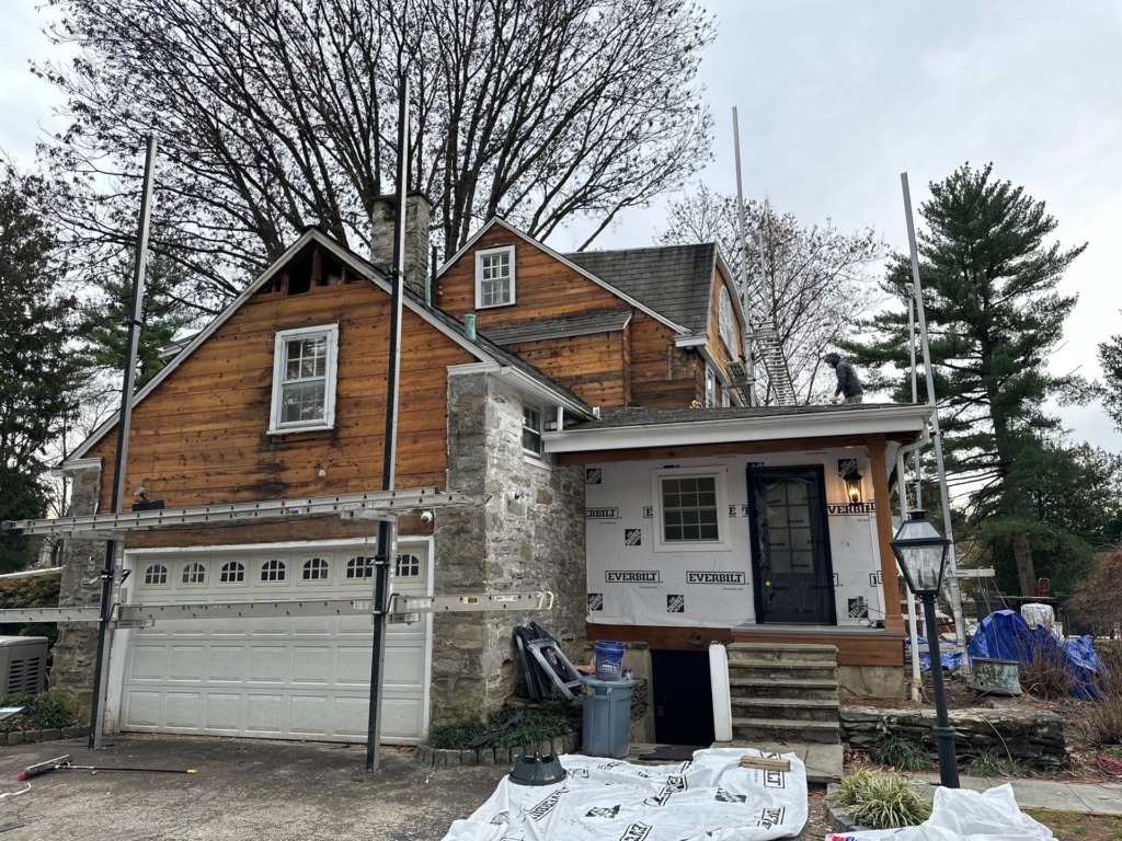 Gladwyne PA home with old wood siding exposed during exterior renovation and siding replacement preparation