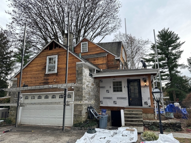 Gladwyne PA home with old wood siding exposed during exterior renovation and siding replacement preparation