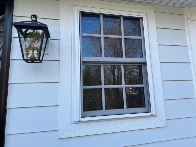 Window capping detail with white James Hardie siding on a completed Gladwyne PA exterior renovation