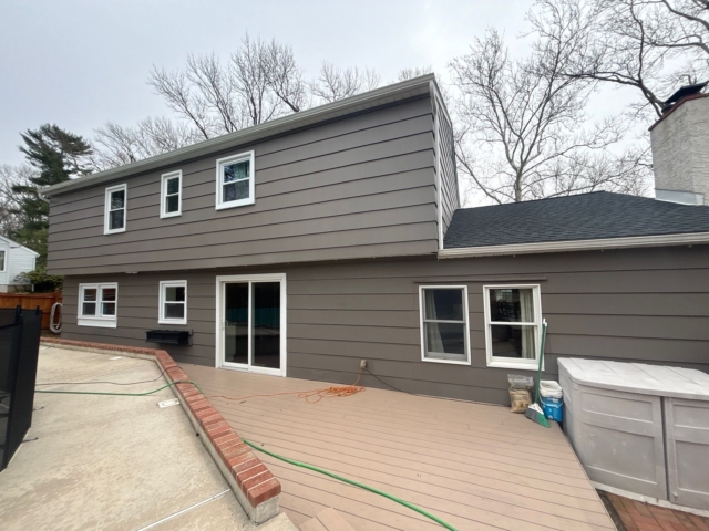 Rear elevation of the Yardley, PA home showing the exterior, windows, deck, and pool area. Rear elevation of the Yardley, PA home showing the exterior, windows, deck, and pool area.
