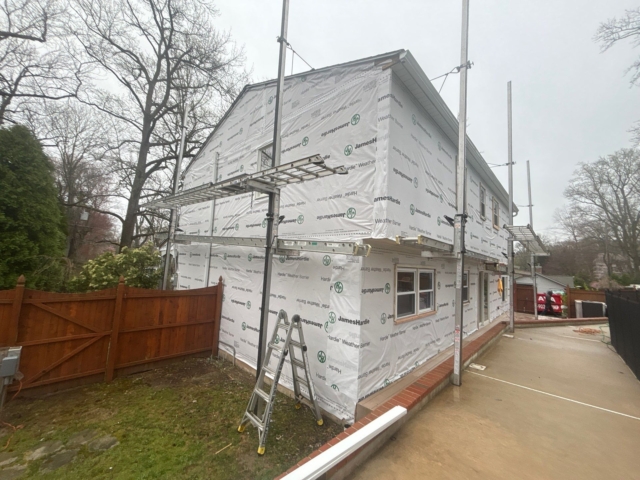 Rear corner of the Yardley home fully covered with James Hardie weather barrier before new siding installation. Rear corner of the Yardley home fully covered with James Hardie weather barrier before new siding installation.