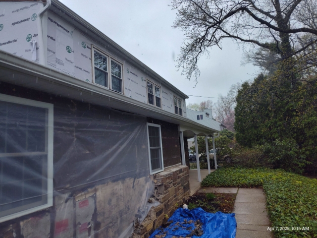 Front side of the Yardley home with upper walls wrapped and lower siding removed during exterior preparation for James Hardie siding. Front side of the Yardley home with upper walls wrapped and lower siding removed during exterior preparation for James Hardie siding.