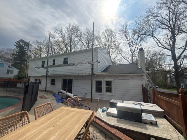 Rear view of the Yardley, PA home during its transformation with Arctic White James Hardie lap siding and new white trim. Rear view of the Yardley, PA home during its transformation with Arctic White James Hardie lap siding and new white trim.