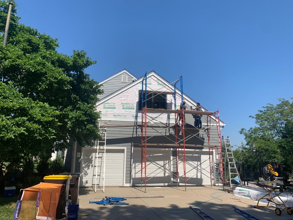 Porter Family Exteriors crew installing James Hardie siding above the garage of a Blue Bell, PA home