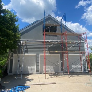 Porter Family Exteriors completing James Hardie siding installation around a three-car garage in Blue Bell