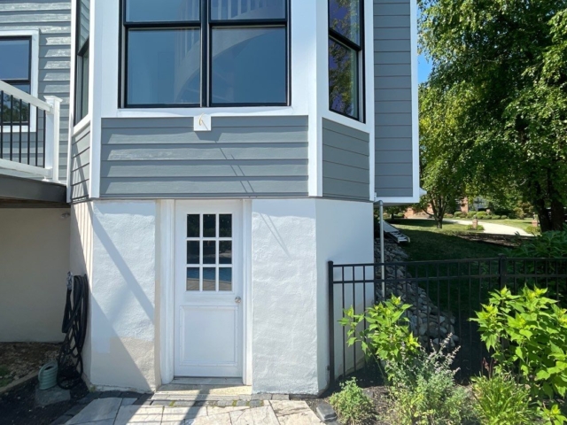 Lower bay window renovated by Porter Family Exteriors with Gray Slate siding and contrasting white trim