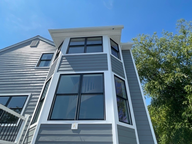 Two-story bay window renovation by Porter Family Exteriors with black windows and Gray Slate siding