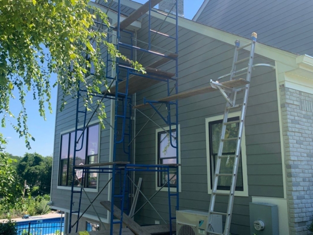 Porter Family Exteriors installing Gray Slate James Hardie siding around black windows in Blue Bell, PA