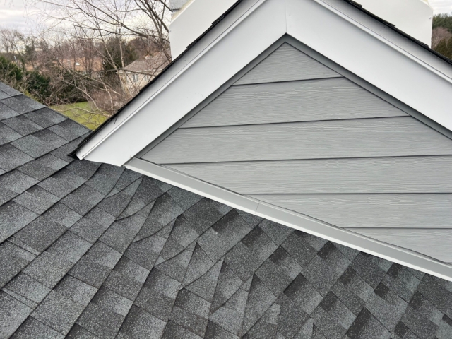 Roof and gable detail completed by Porter Family Exteriors with new shingles, siding, trim, and flashing