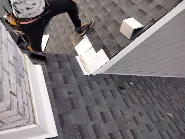 Porter Family Exteriors roof installation in progress with shingles and metal flashing around exterior junctions