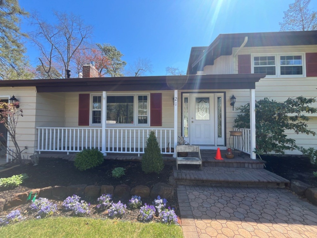 Front entry and original siding before exterior renovation in Medford NJ