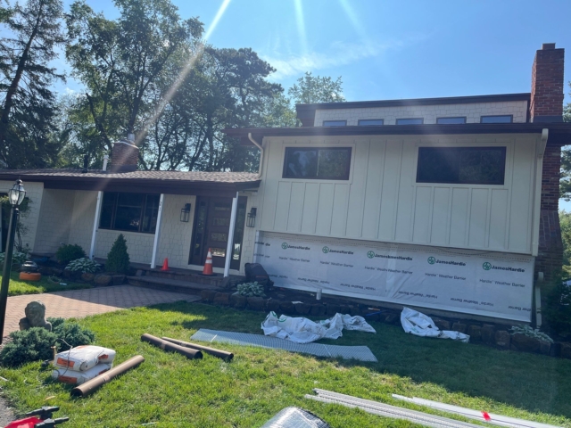 Front exterior renovation showing board and batten and staggered shake siding in progress